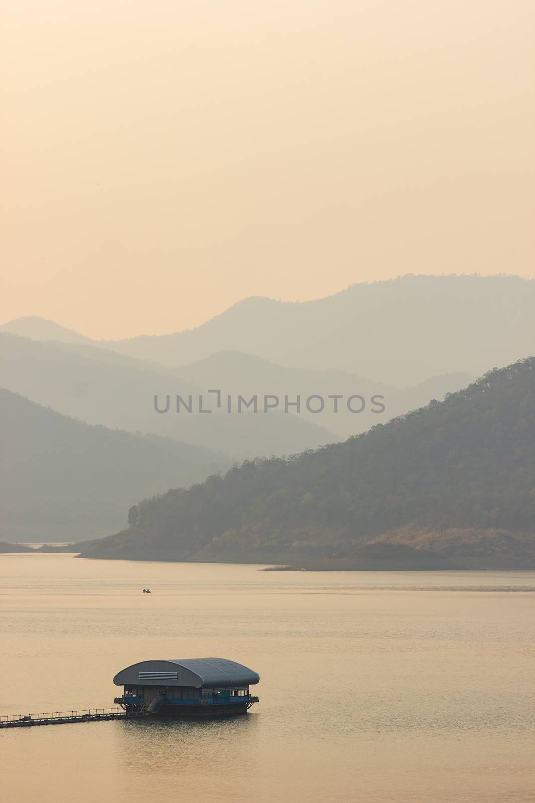 Raft floating on the middle of a dam or lake in the evening.