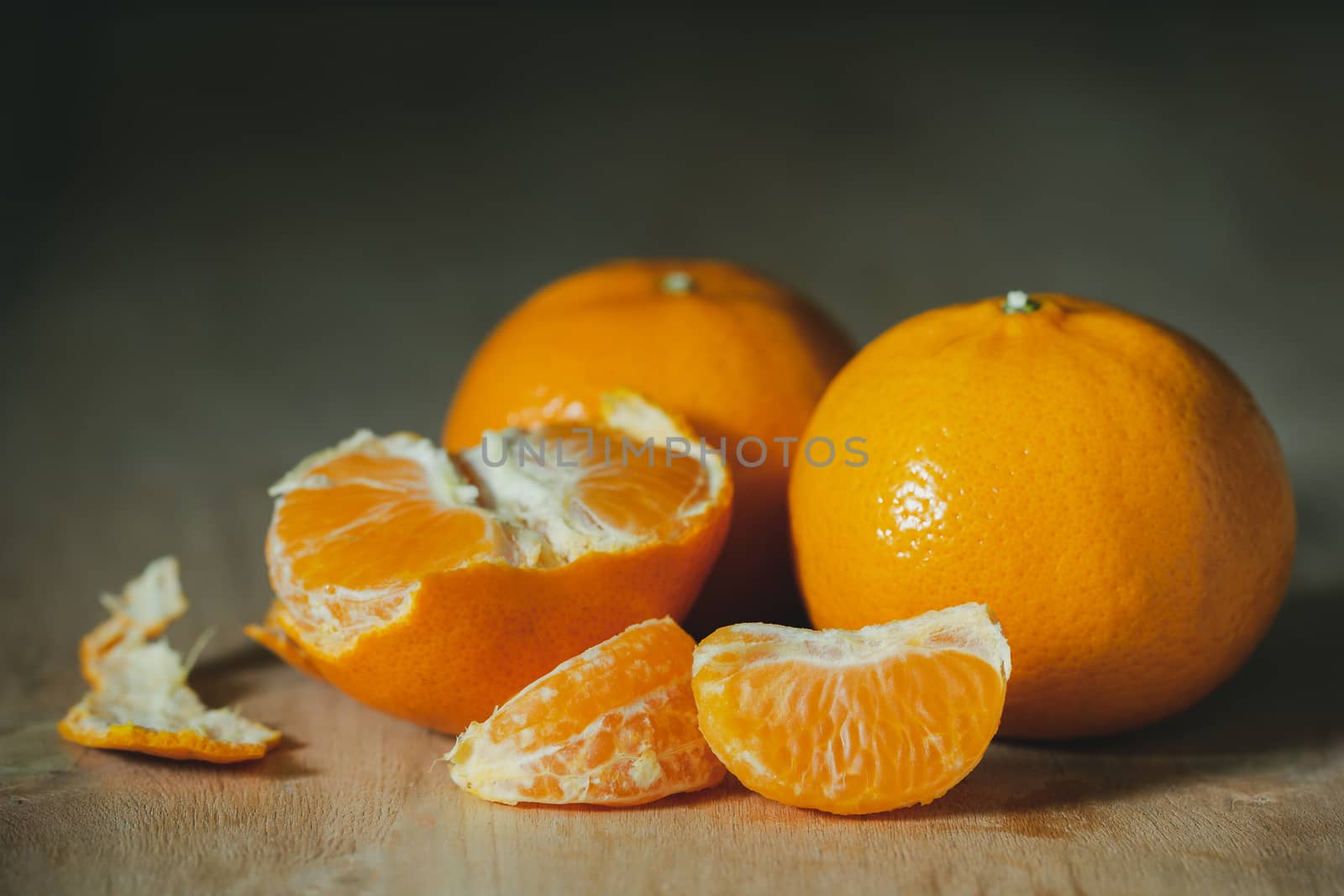 Tangerine peeled on a wooden table. The concept of love and health care.