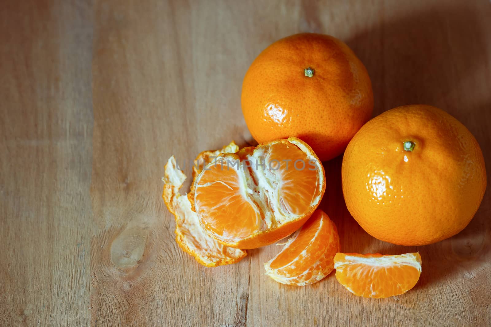 Tangerine peeled on a wooden table. The concept of love and health care.