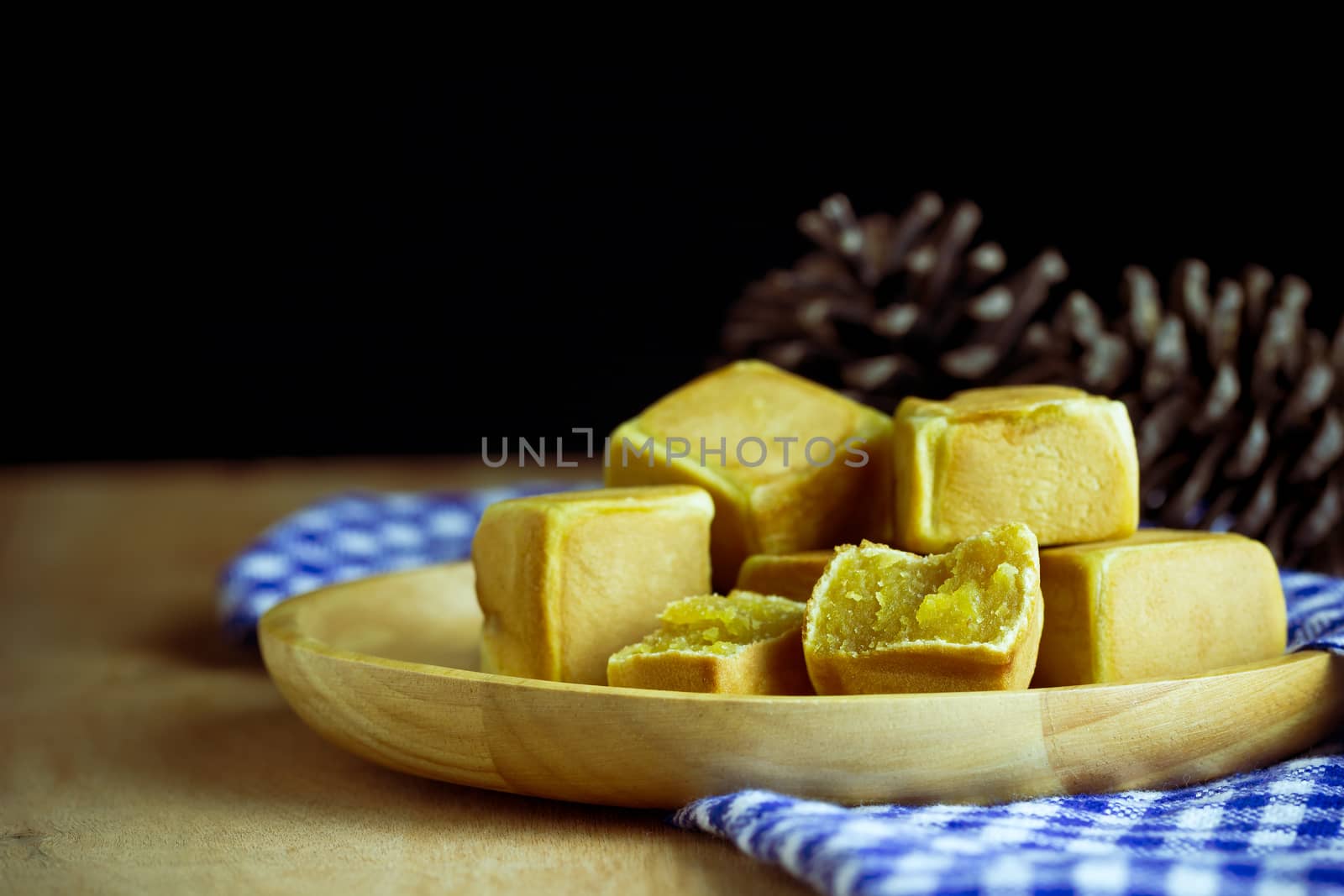 Chinese cakes dice shaped and dry pine flower are placed on a br by SaitanSainam