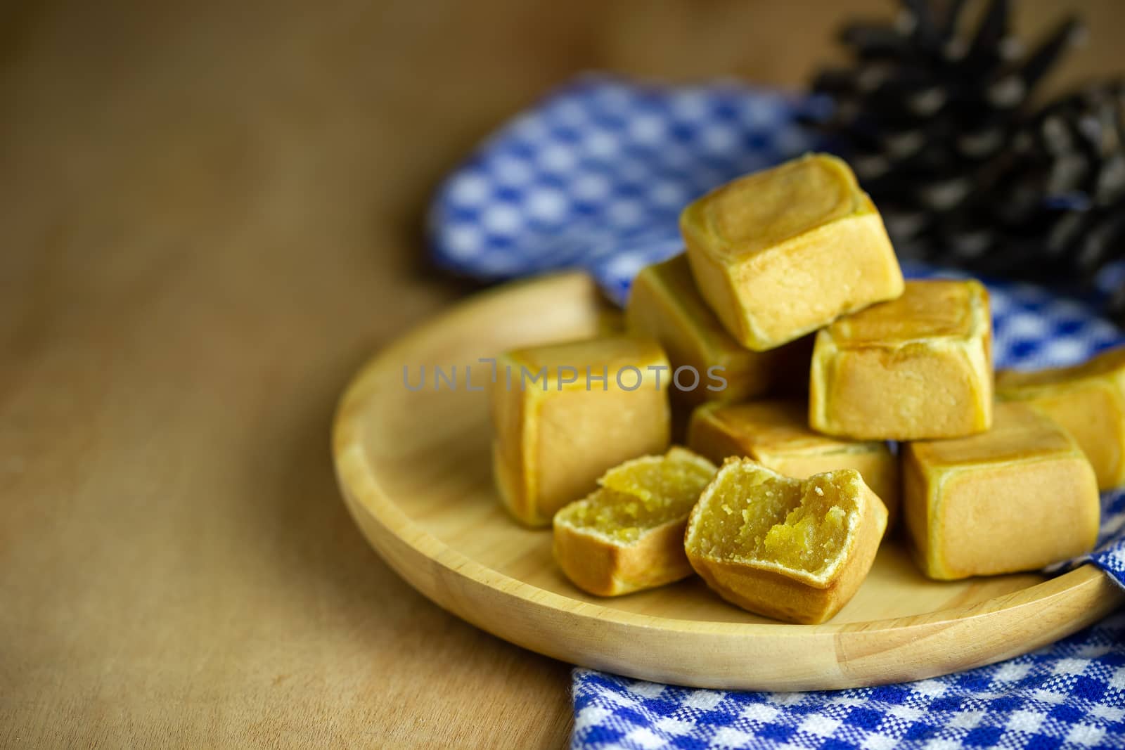 Chinese cakes dice shaped and dry pine flower are placed on a br by SaitanSainam