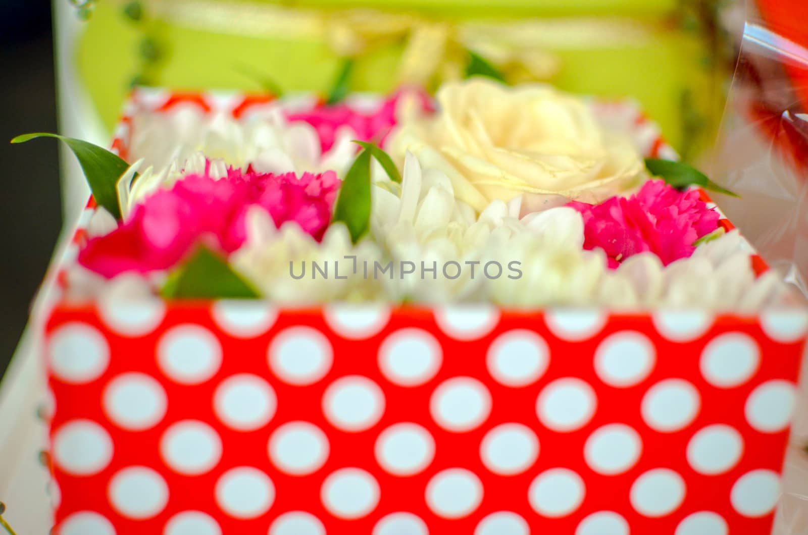 Beautiful bouquet of mixed flowers of chrysanthemums, cloves and roses in red box by kimbo-bo