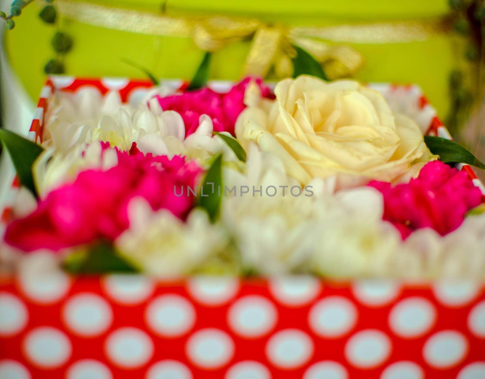 Beautiful bouquet of mixed flowers of chrysanthemums, cloves and roses in red box by kimbo-bo