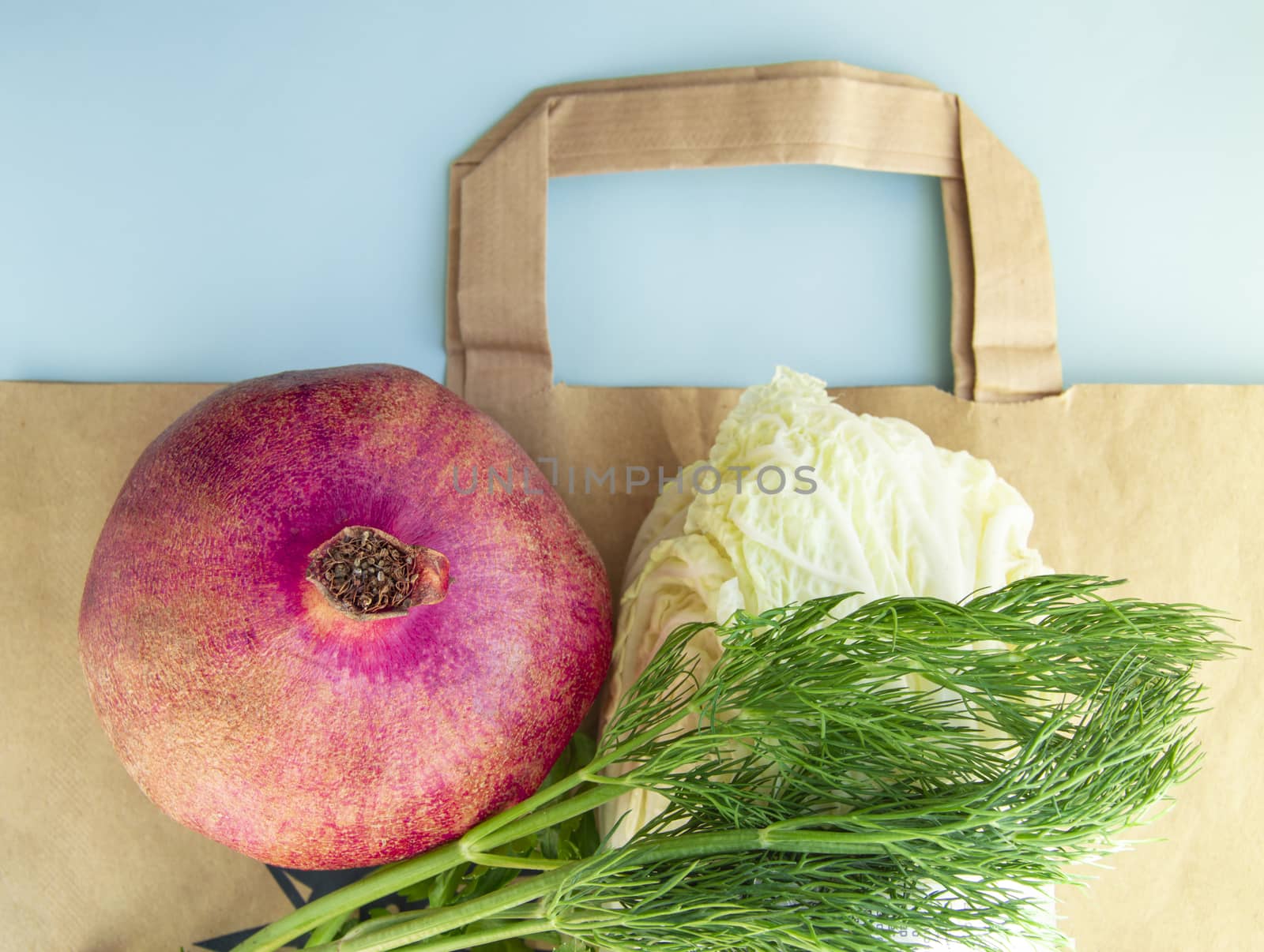 Flat lay, Healthy fruits and vegetables for proper nutrition on top of a paper bag, the concept of abandoning plastic bags and shopping at a diet by claire_lucia