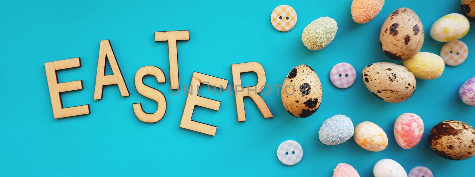 Quail Easter eggs on blue background. Flat lay, top view. Easter concept. by natali_brill