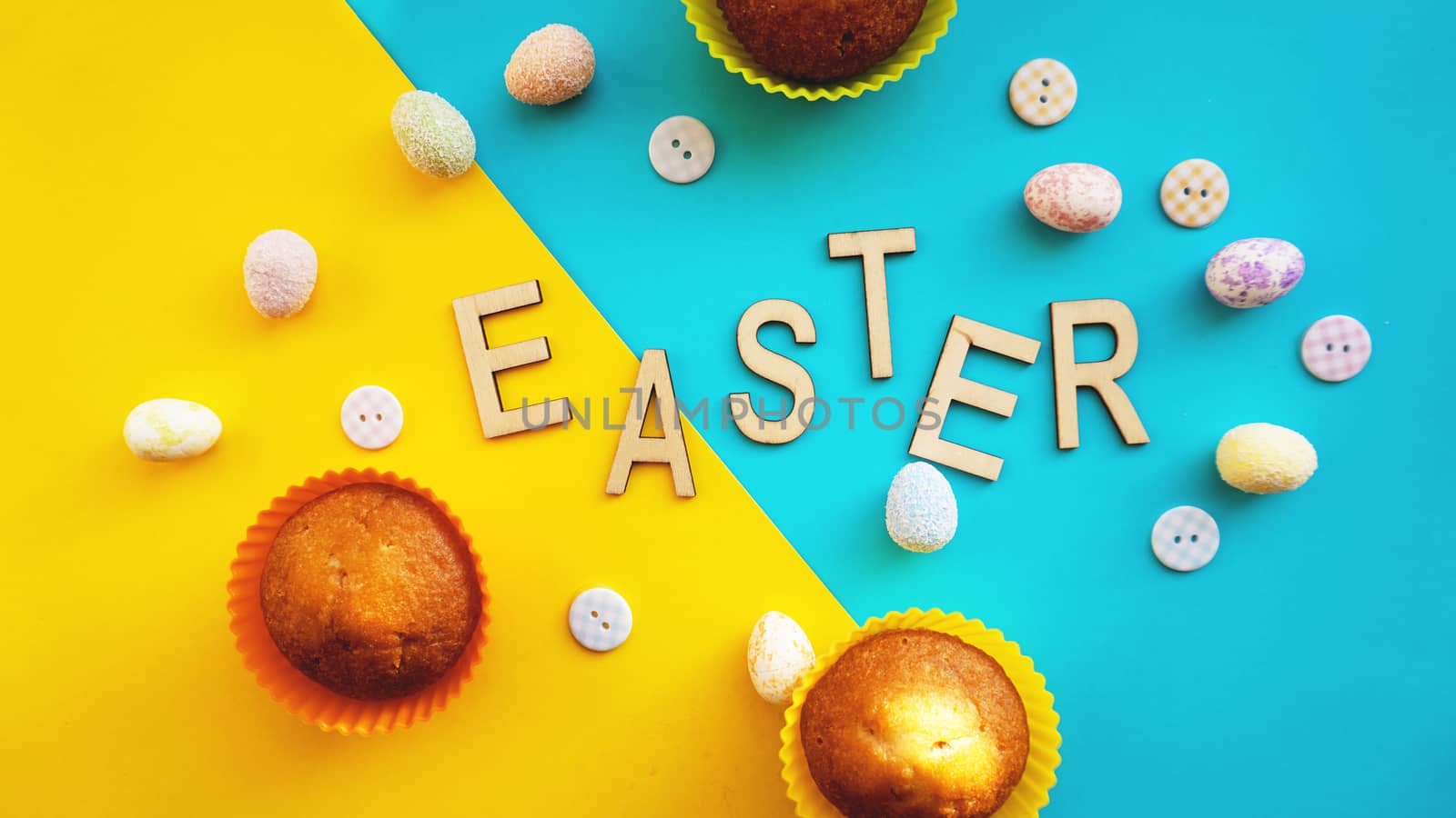 Decor Easter eggs on blue background. Flat lay, top view. Easter concept banner. Easter text