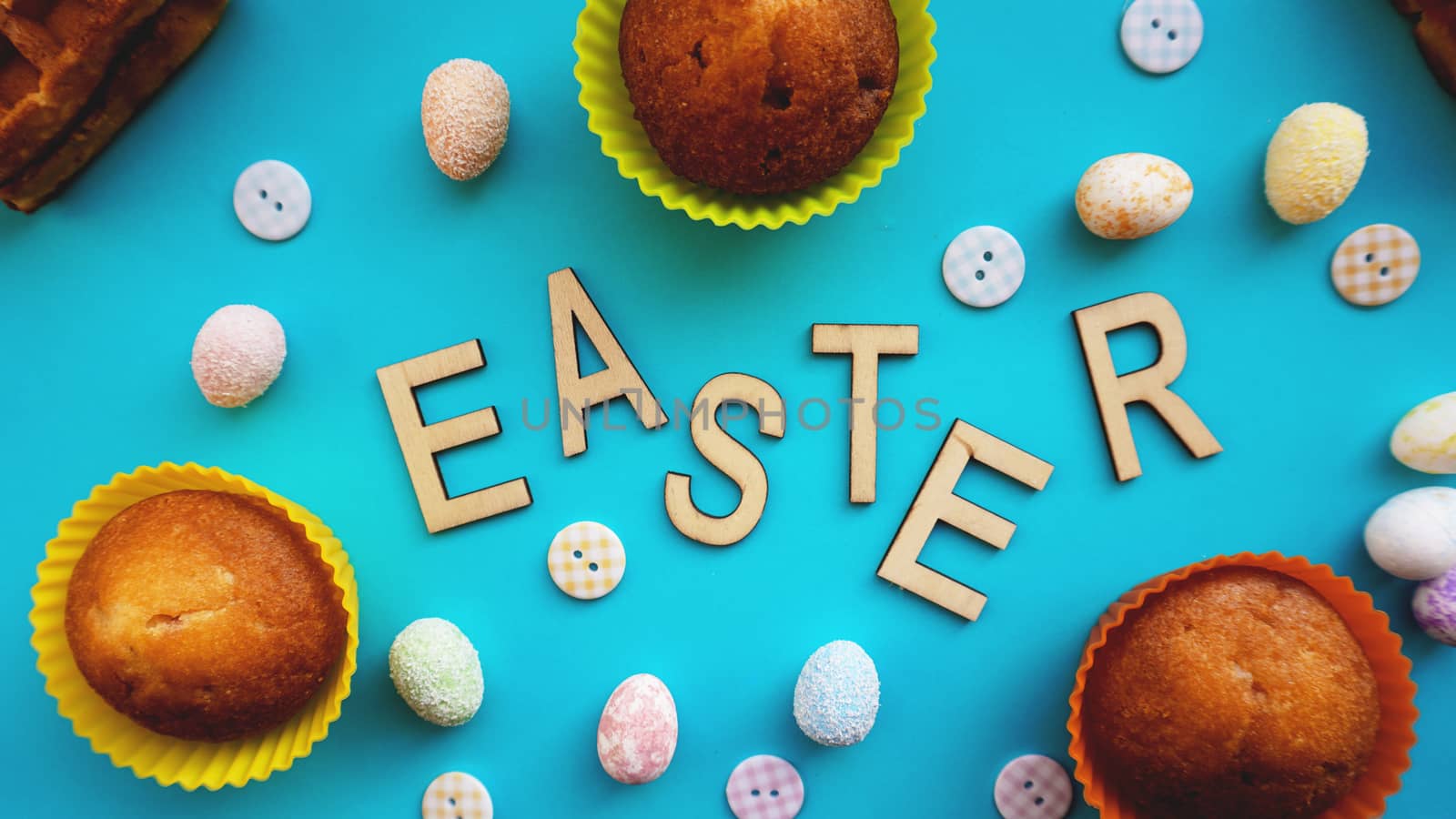 Decor Easter eggs on blue background. Flat lay, top view. Easter concept banner. Easter text