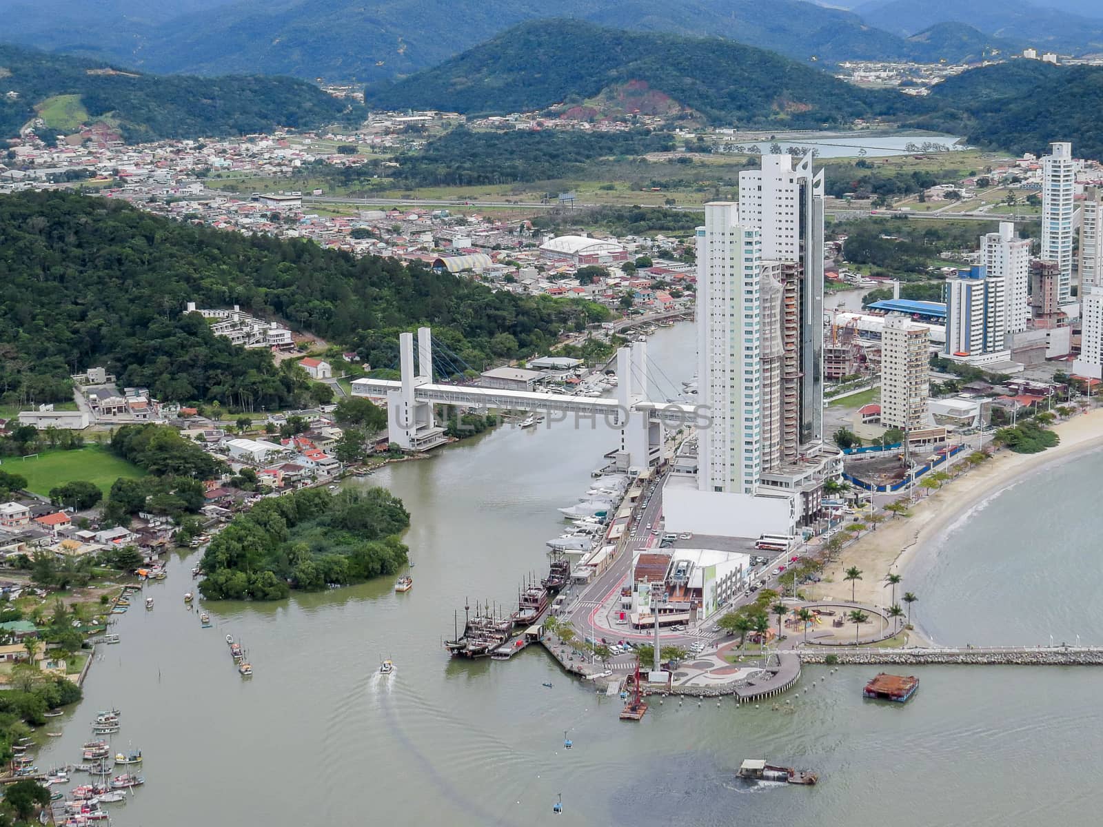 Aerial view of city by the sea, in the drainage of the river, with port and boats, in summer day