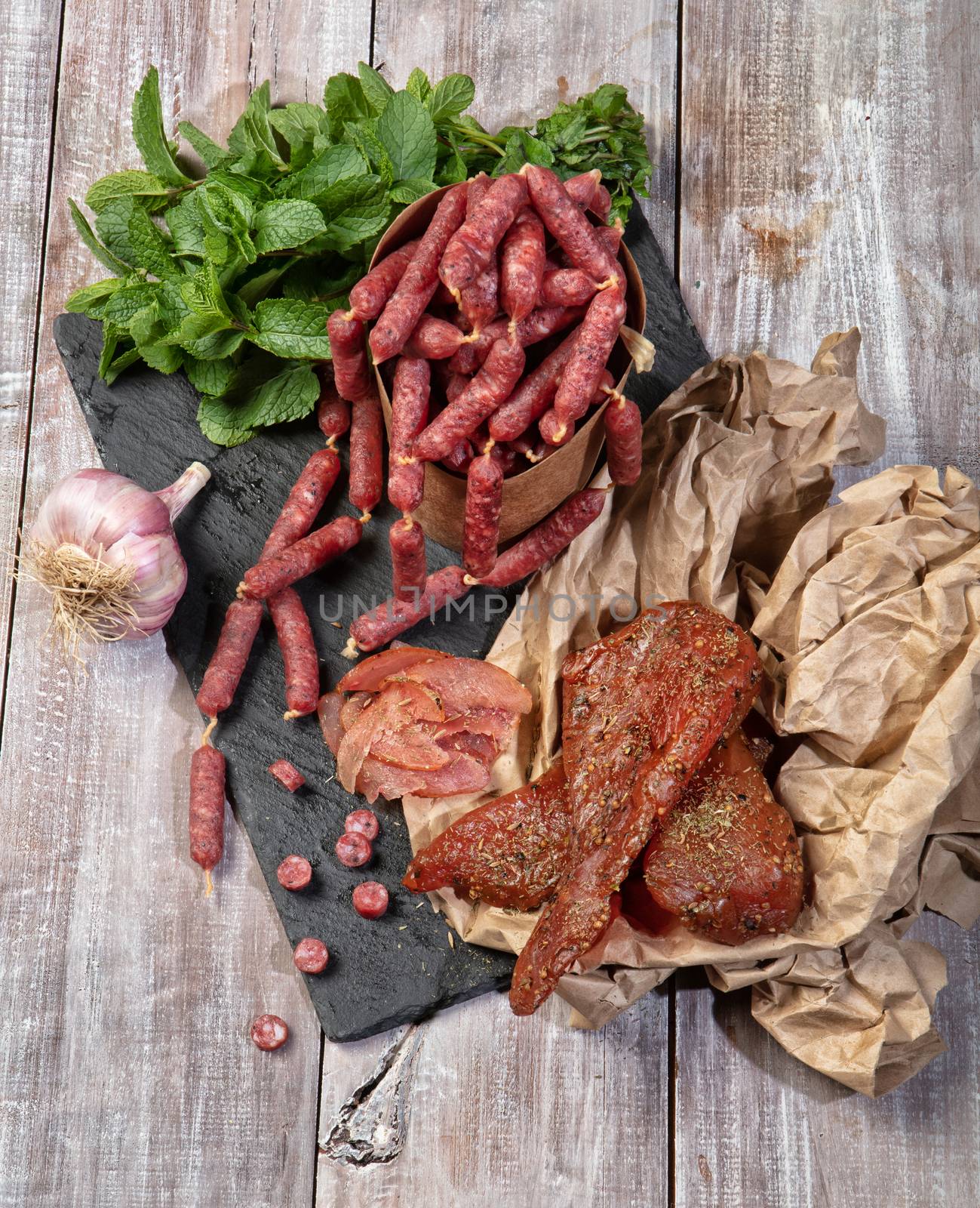 Ham and vegetables on an old wooden background