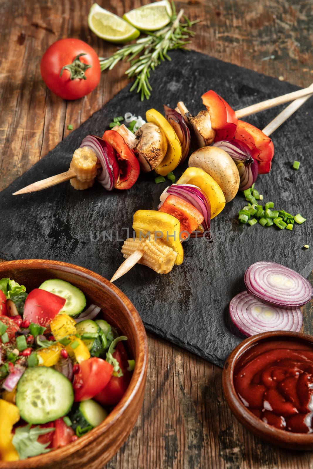 Shaslik and vegetables on a wooden table