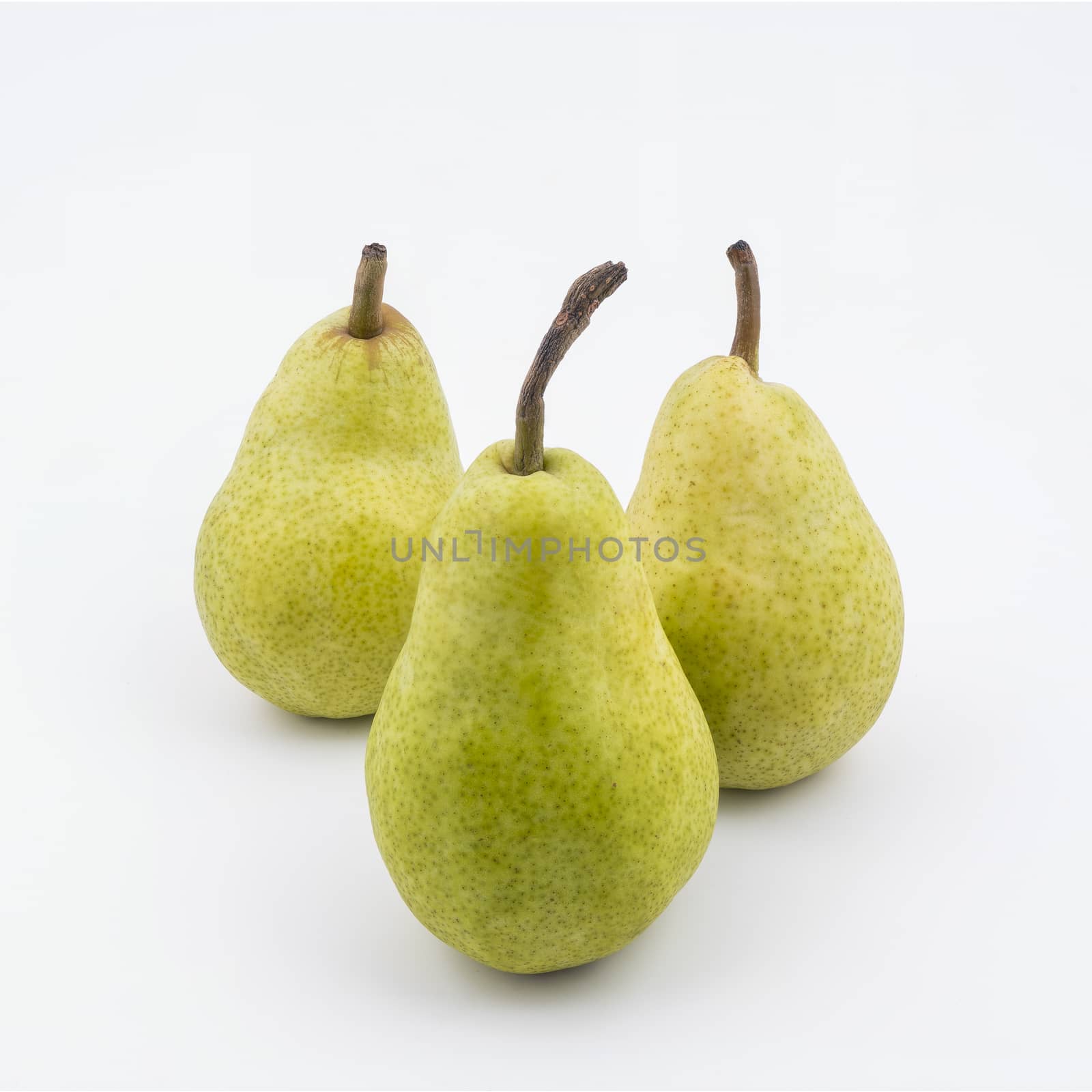 Three pears isolated on a white surface