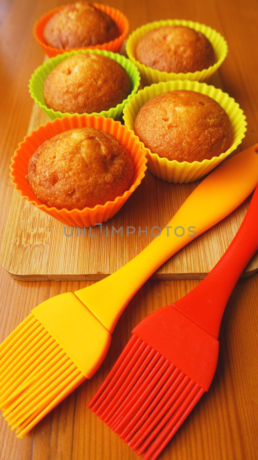 Simple mini muffins in colorful silicone bakeware. Kitchen and cooking concept by natali_brill