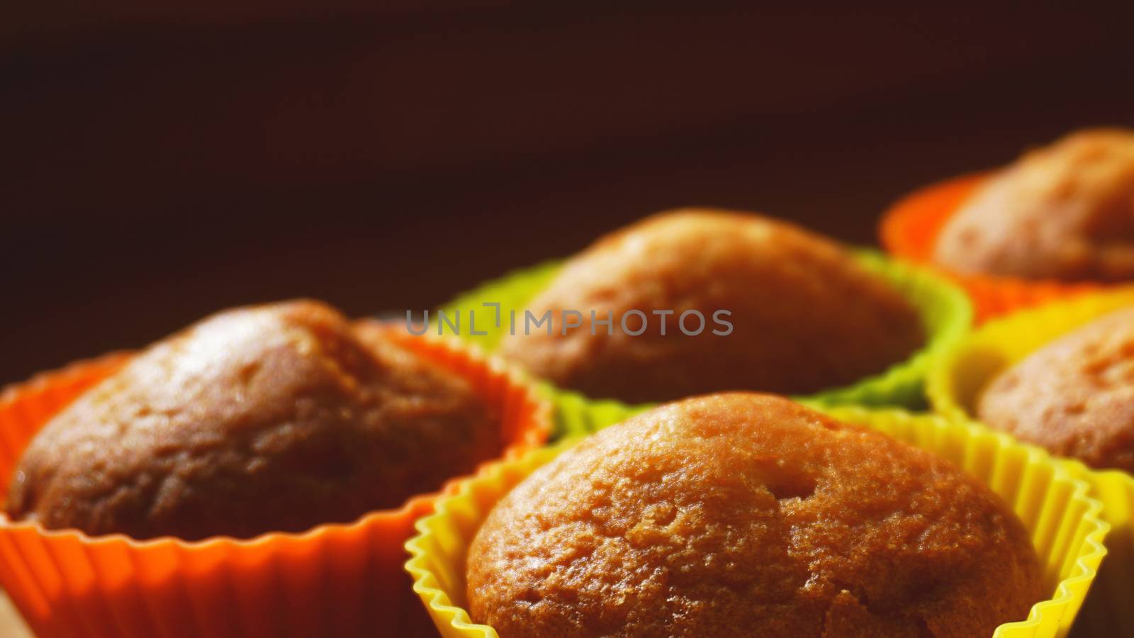 Simple mini muffins in colorful silicone bakeware. Free space. Selective focus. Closeup