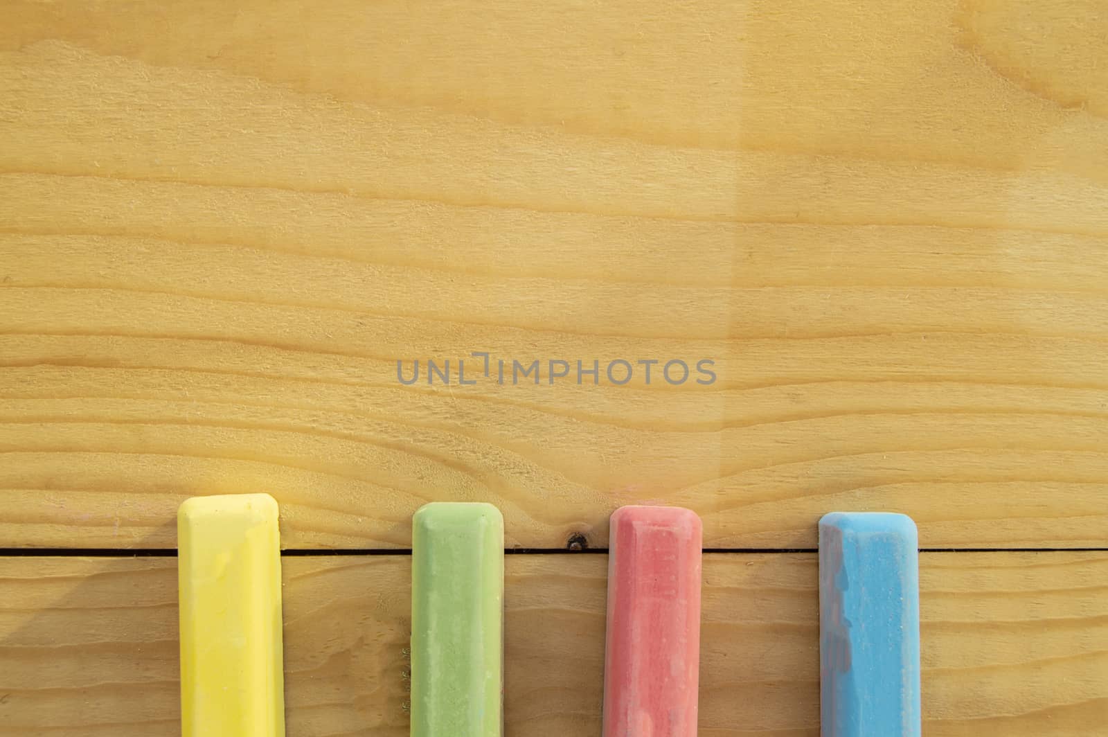 School supplies colored crayons on a light background of the Board stationery. Back to school, the concept of minimalism, flat lay, copyspace.