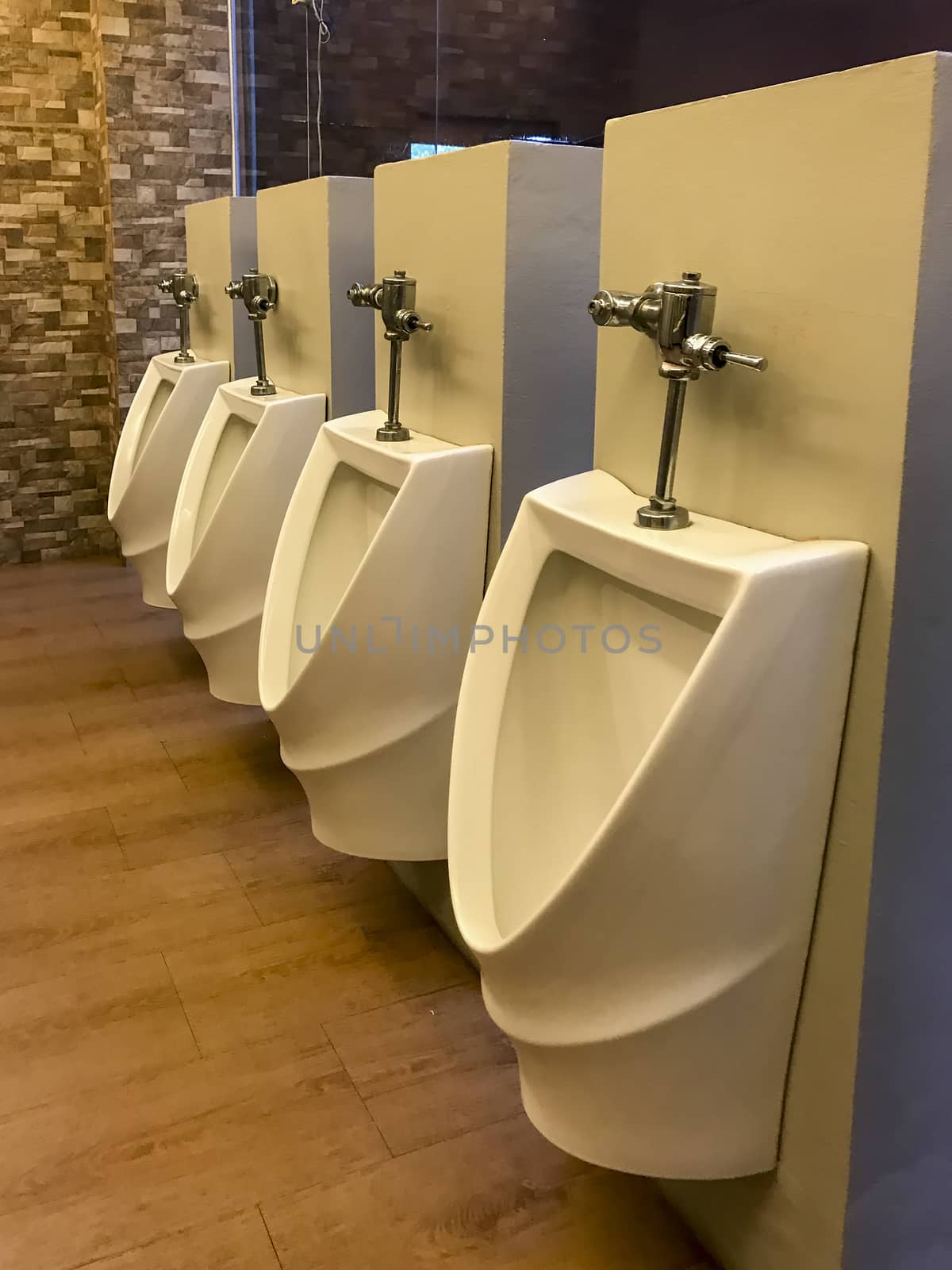 White men's urinals lined in a toilet by TakerWalker