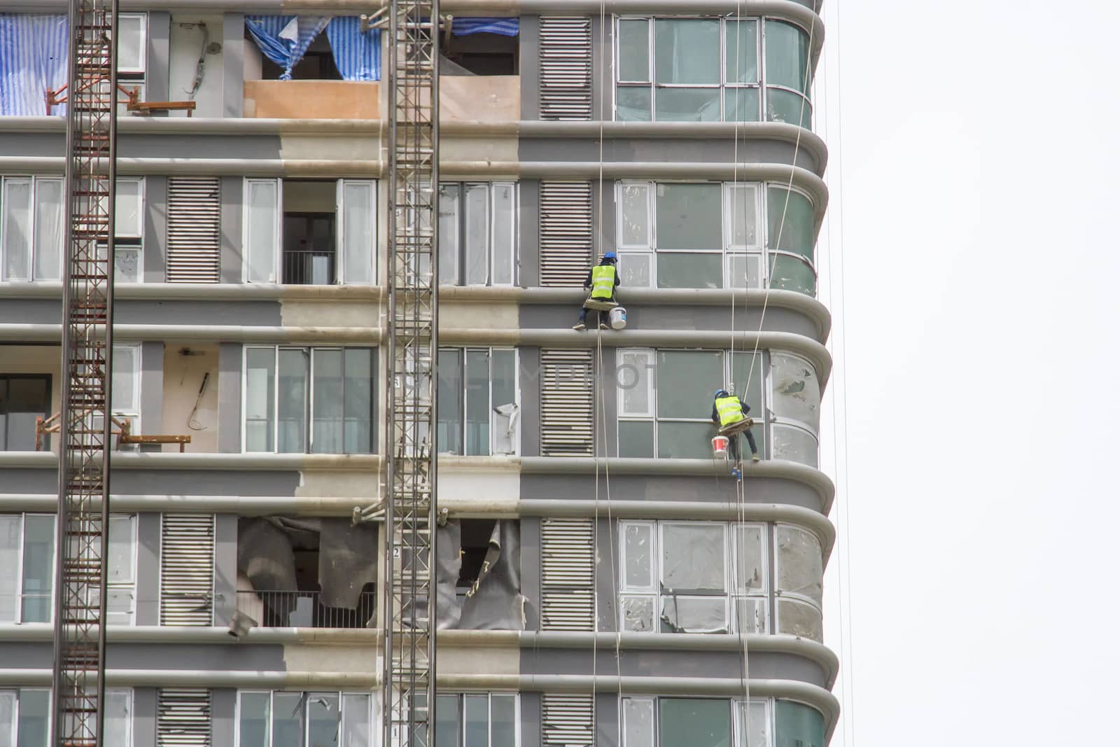 Worker scaffolding on the side of the building by TakerWalker