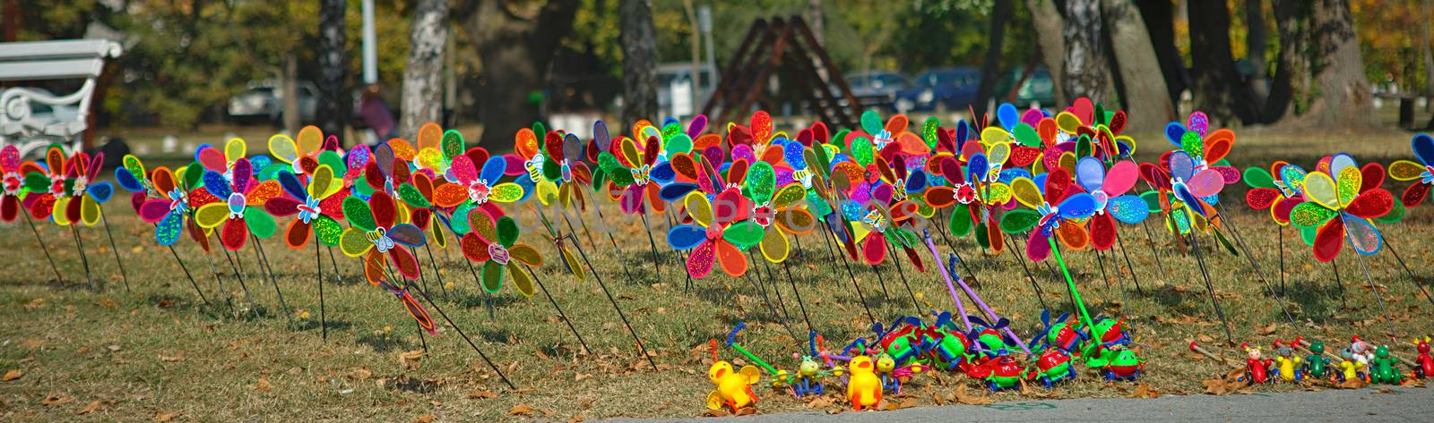 Bunch of colorful children windmill toys on a field