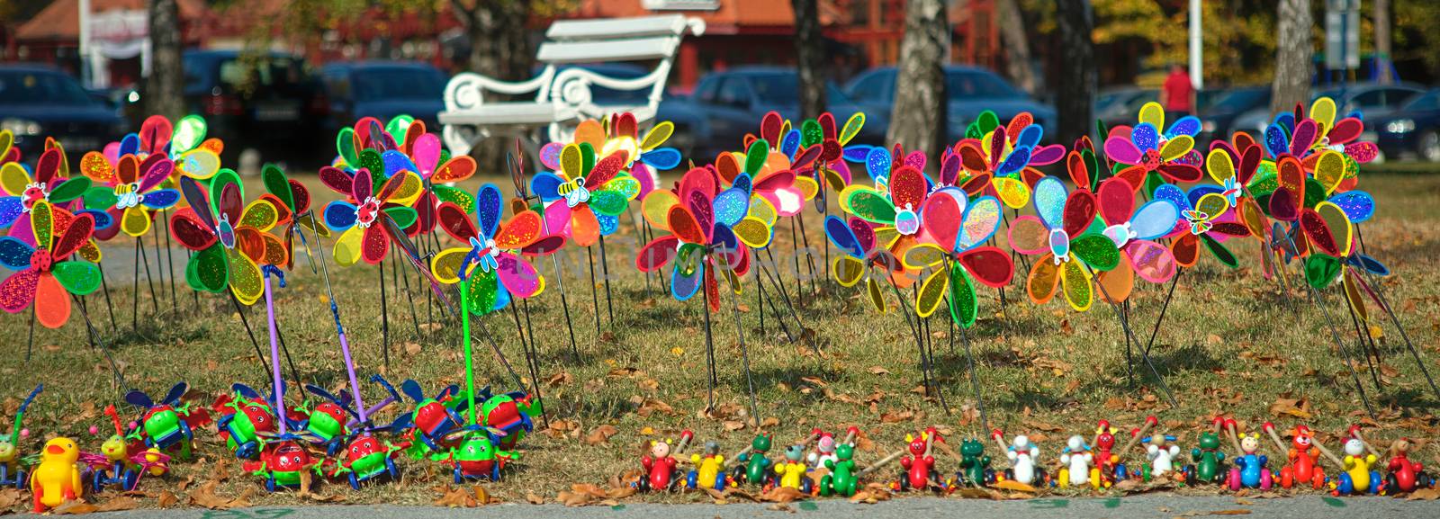 Bunch of colorful children windmill toys on a field by sheriffkule
