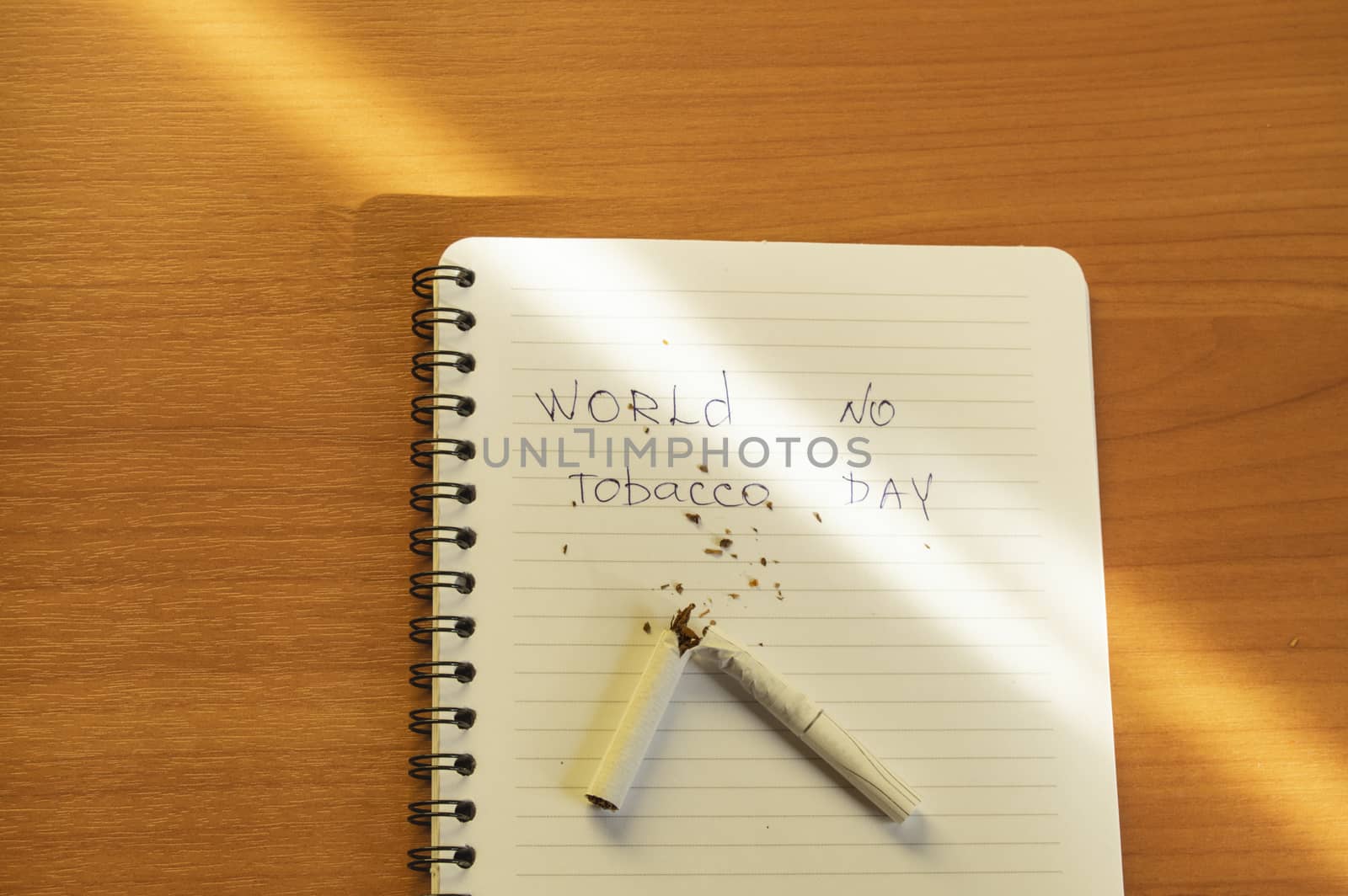 Flat lay, cigarettes and the inscription world no tobacco day written in a notebook, a healthy lifestyle without cigarettes.