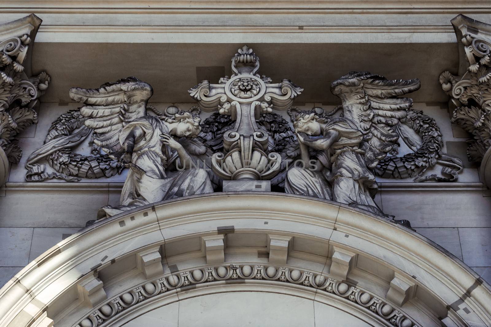 A close-up exterior view on a sculptural composition above the entrance of Dom Berliner, also known as the Berlin Cathedral in the historic city of Berlin in Germany.