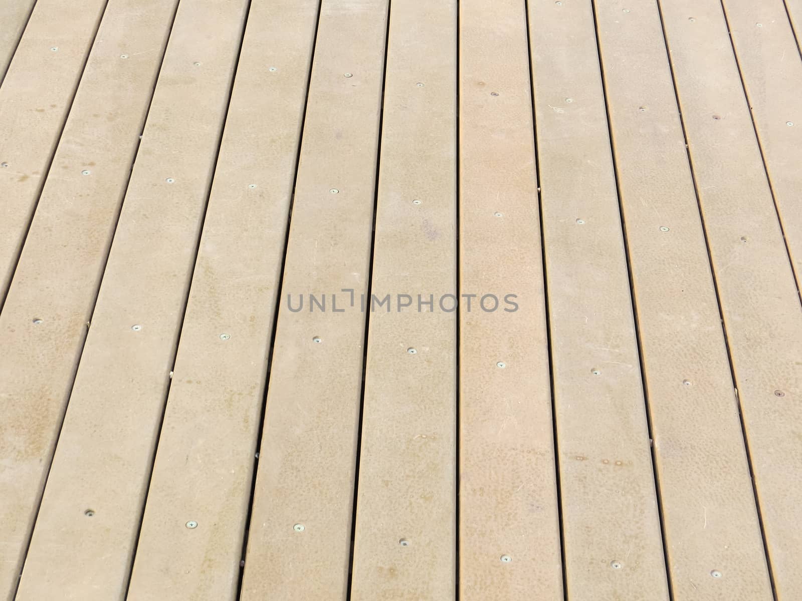Detail of wooden floorboards in perspective vertical, on clear day.