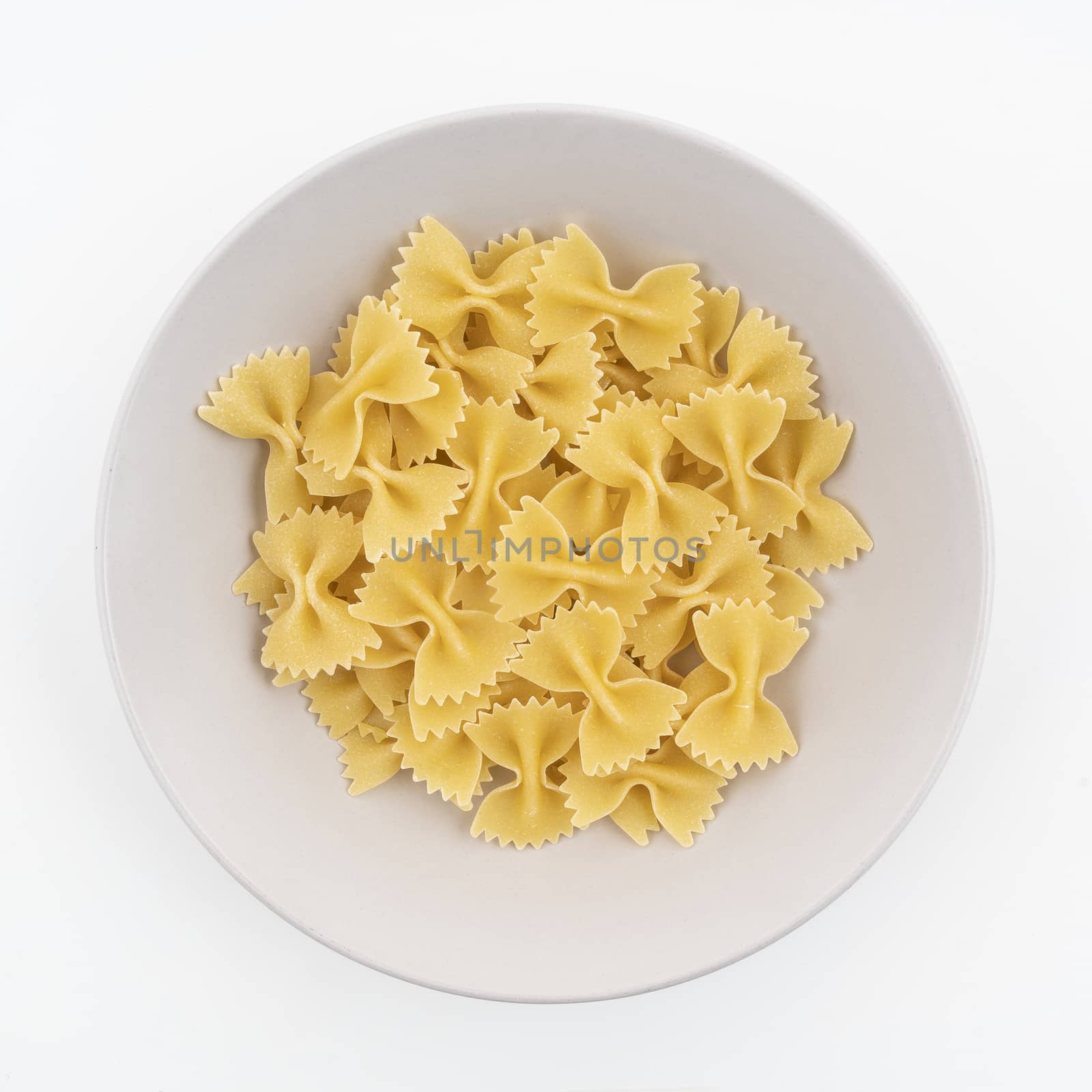 Some dried butterfly format pasta on a plate