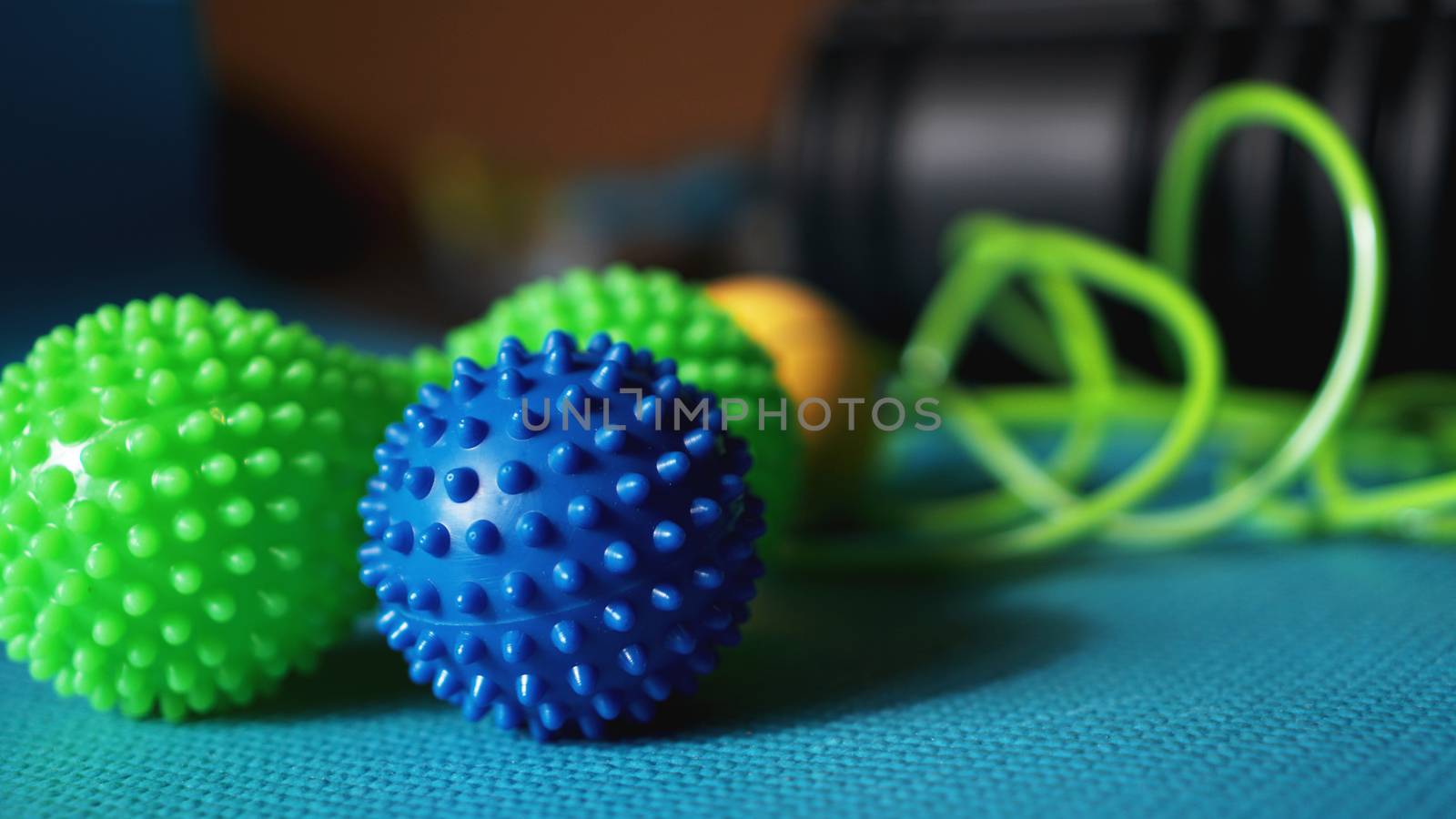 Massage ball roller for self massage, reflexology and myofascial release on blue by natali_brill