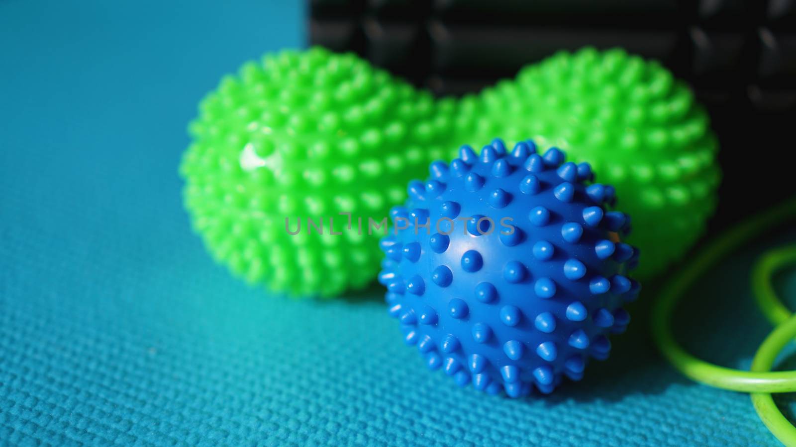 Massage ball roller for self massage, reflexology and myofascial release on blue by natali_brill