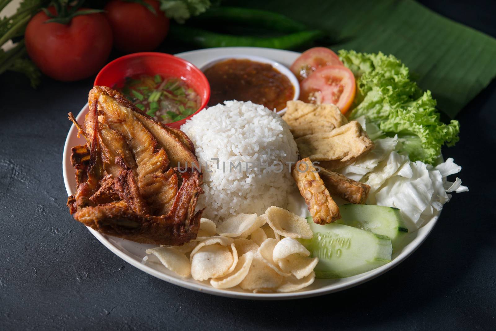 Nasi lemak kukus with fried chicken, popular traditional Malaysian local food.