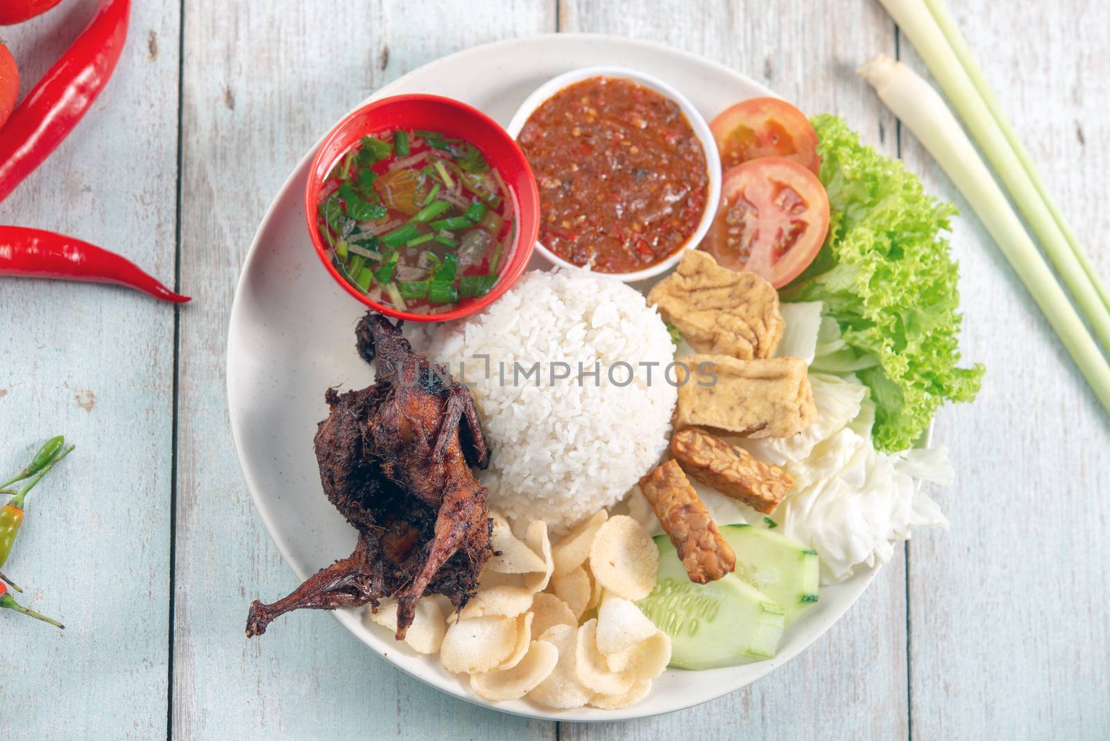 Nasi lemak kukus with quail meat, popular traditional Malaysian local food. Flat lay top down overhead view.