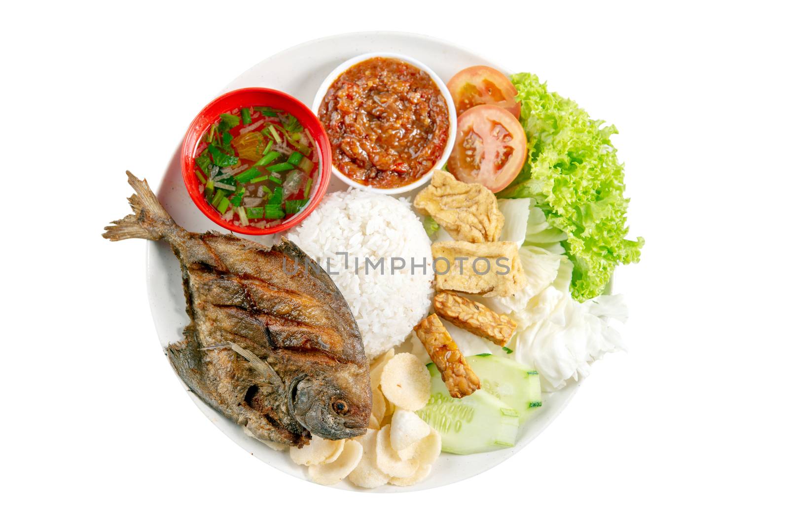 Fried pomfret fish and rice, popular traditional Malay or Indonesian local food. Isolated on white background. Flat lay top down overhead view.