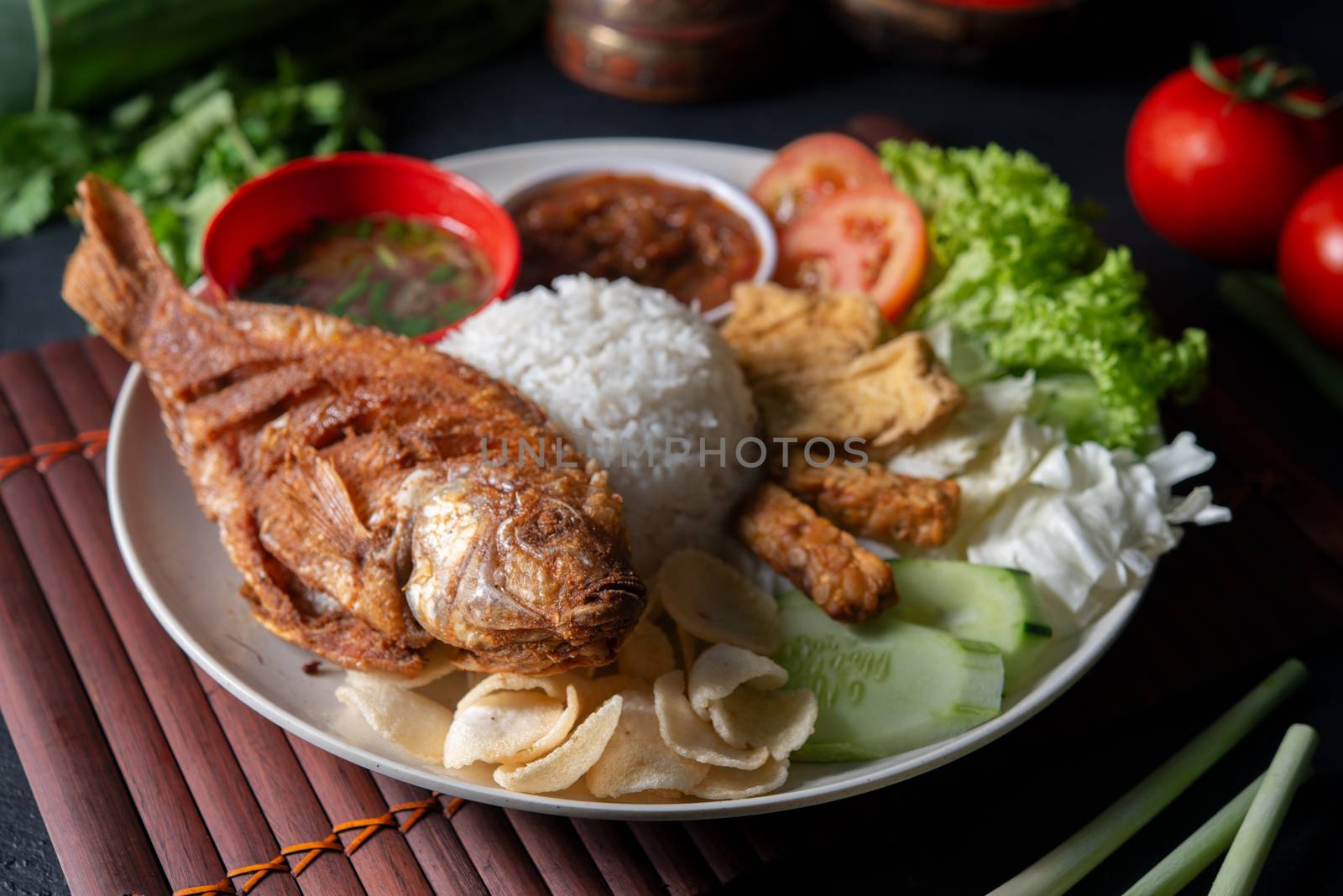 Fried tilapia fish and rice, popular traditional Malay or Indonesian local food.