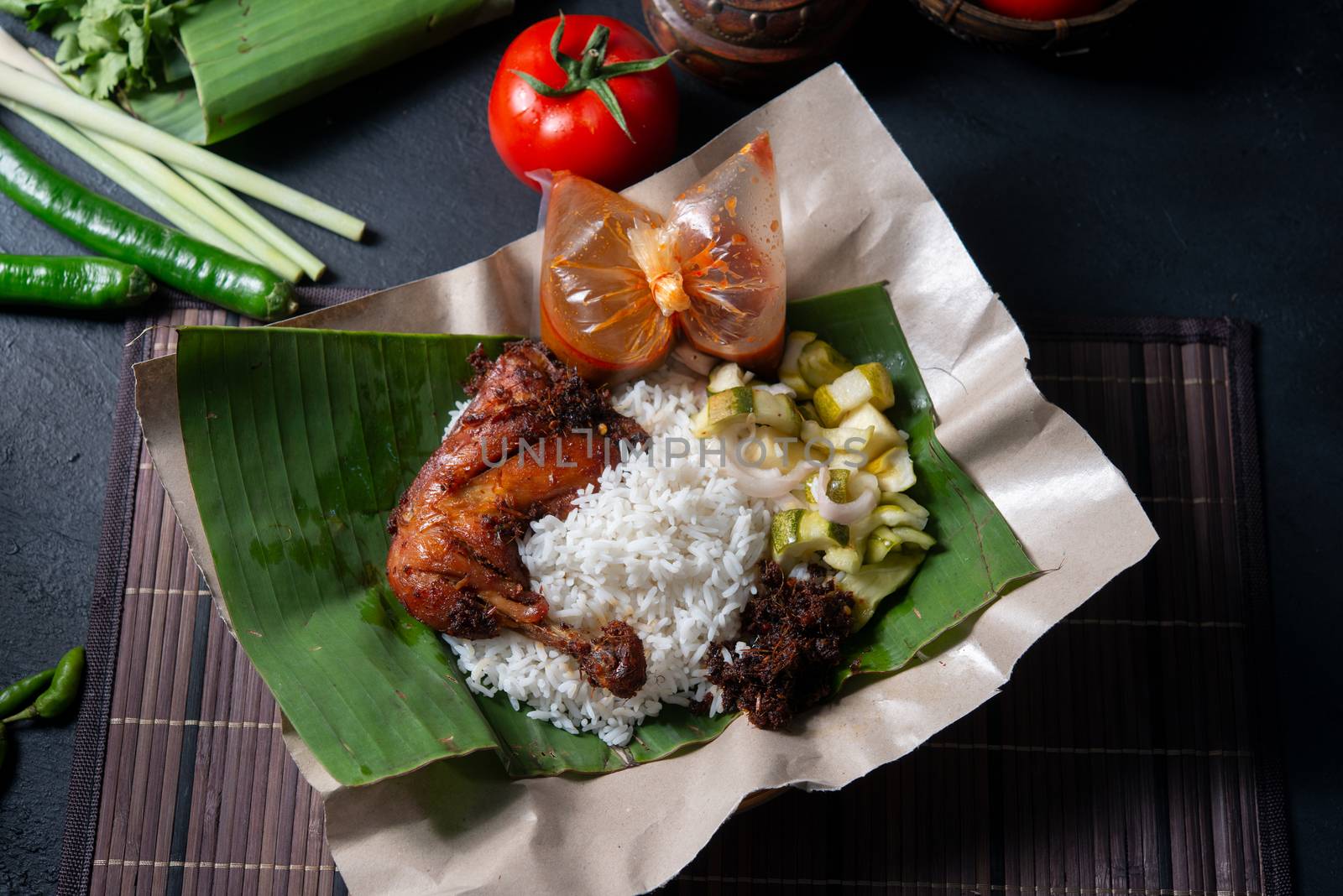 Nasi lemak kukus with chicken, popular traditional Malay local food. Flat lay top down overhead view.