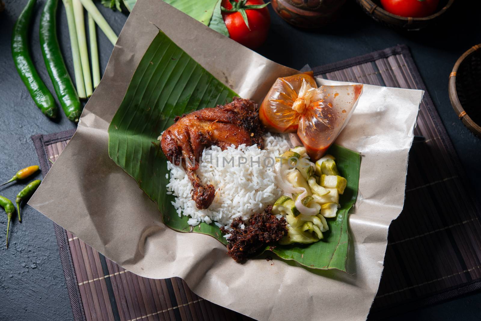 Nasi lemak kukus with chicken, popular traditional Malay local food. Flat lay top down overhead view.