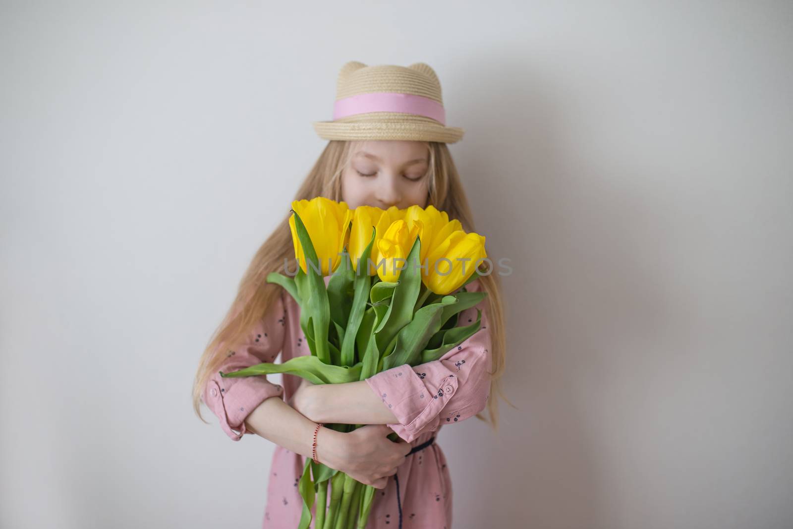 Teen girl smelling yellow tulips, focus on flowers by Angel_a