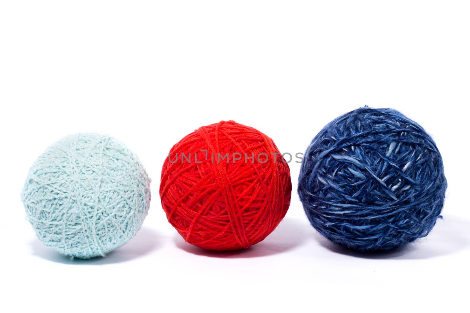 a set of balls of thread for knitting, isolate, homemade needlework, three multi-colored skeins of wool yarn