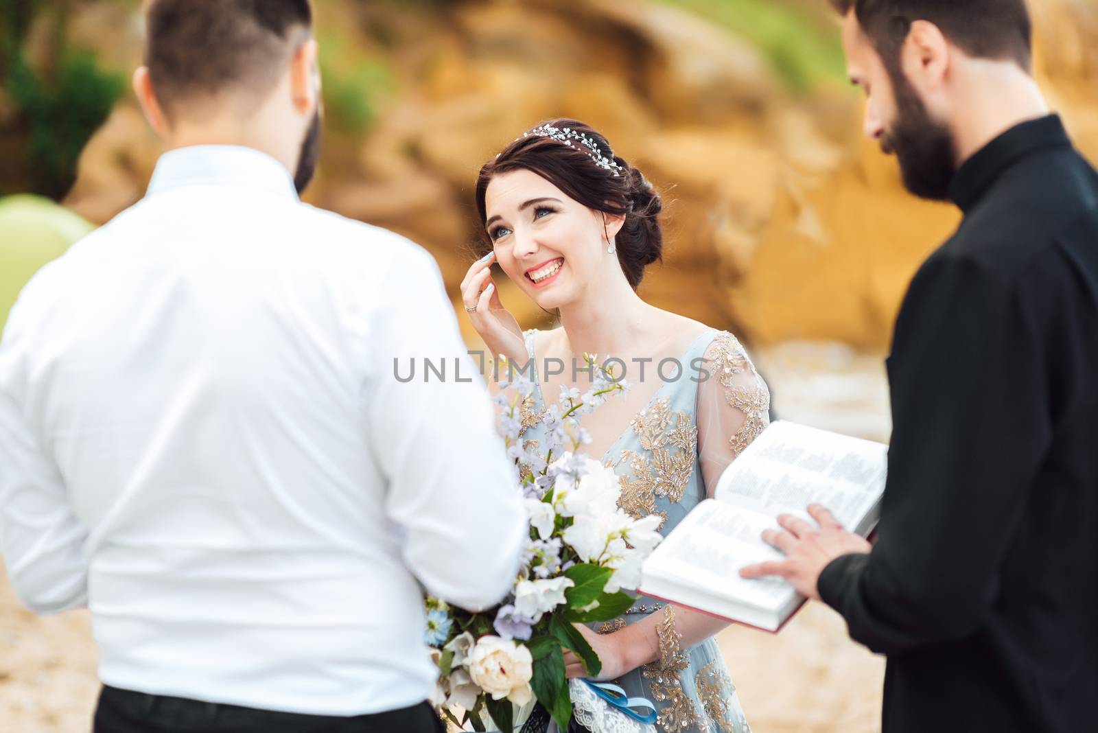 wedding couple on the ocean with a priest by Andreua