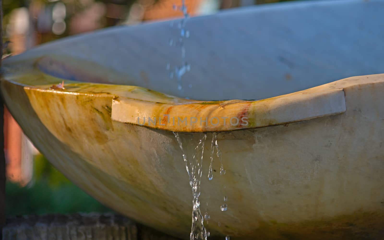 Water dripping from a white marble fountain