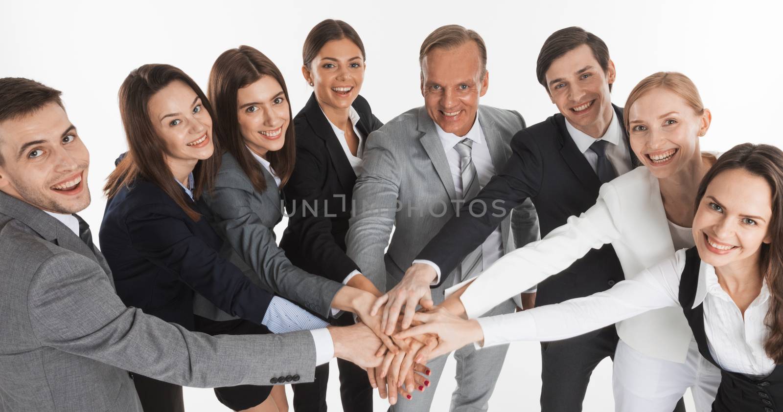 Business people group team hold pile hands, businesspeople putting their hand on top each other, isolated over white background