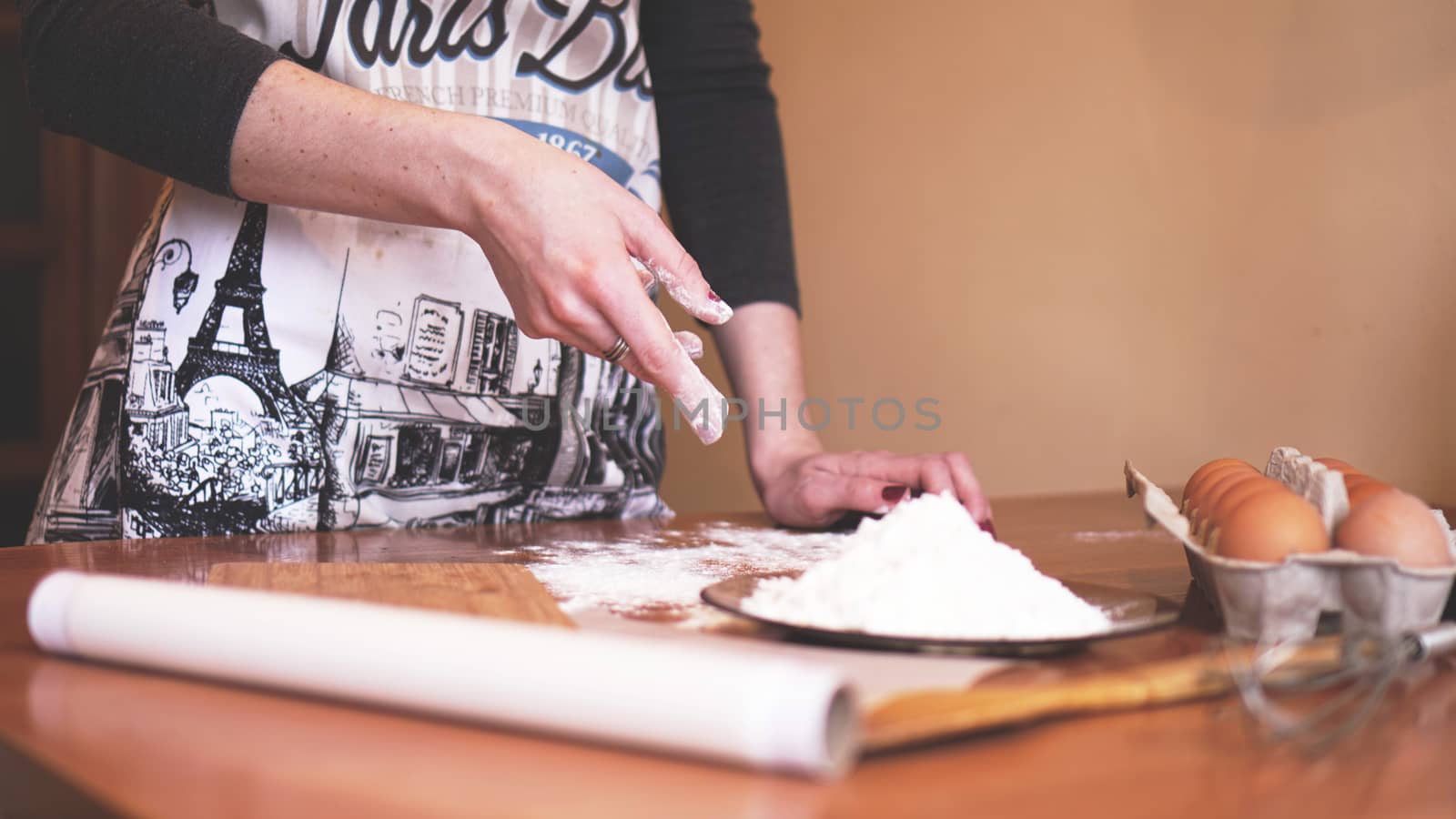 Close up scene of female hands making dough. Soft focus, kitchen, cooking ingredients