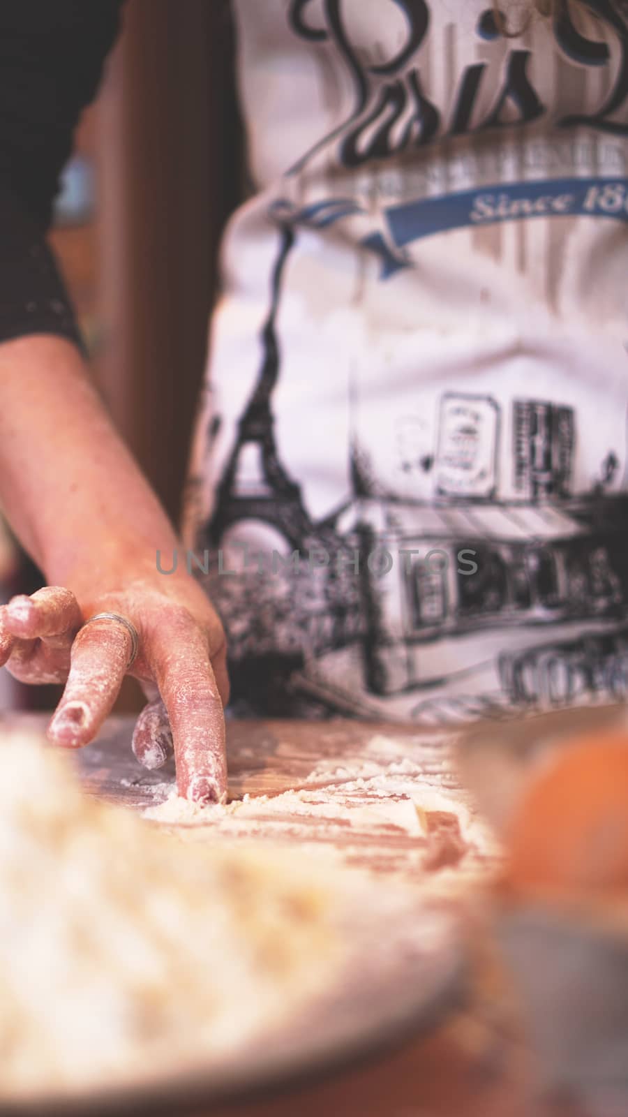 Close up scene of female hands making dough. Soft focus, kitchen, cooking ingredients