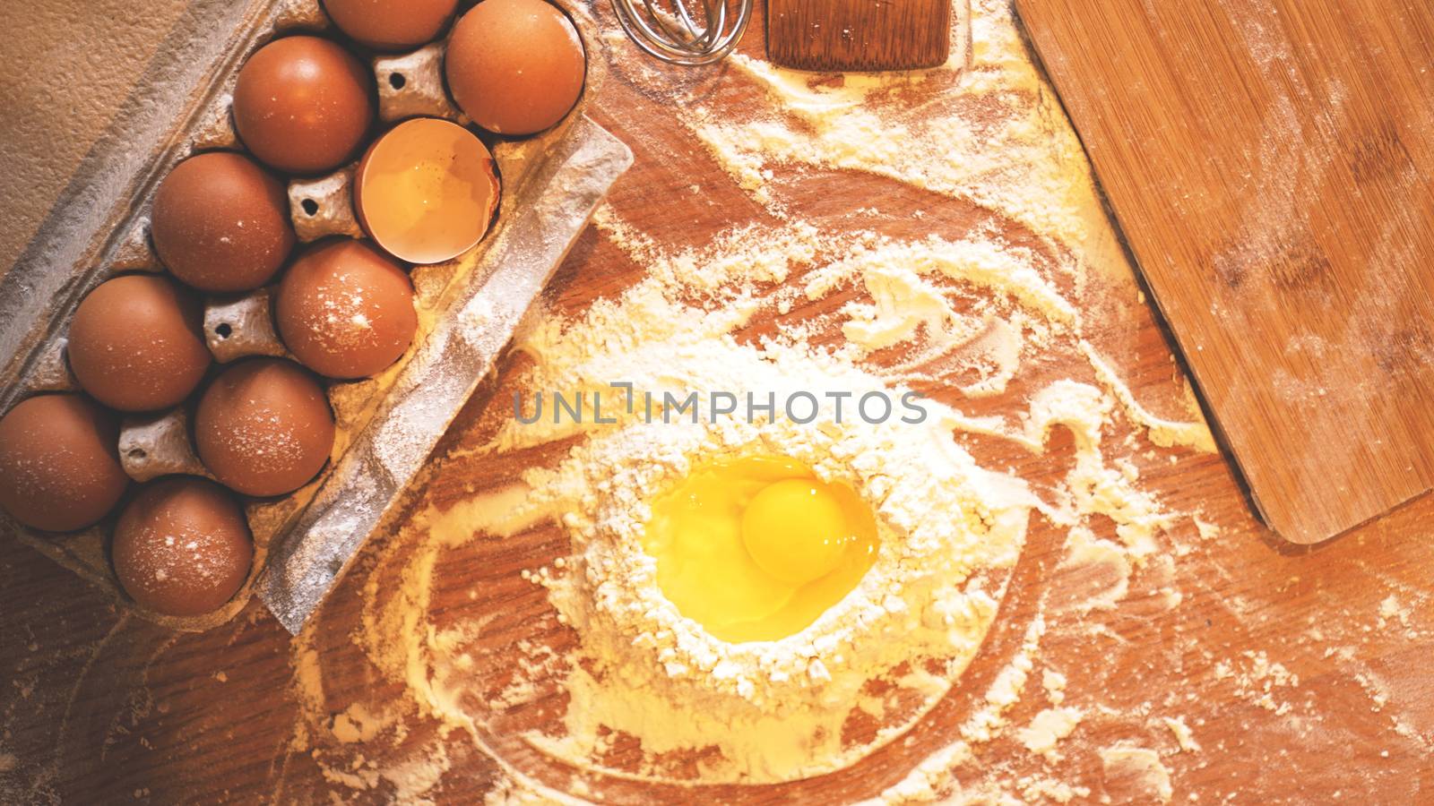 Ingredients and utensils for baking on a pastel wooden background, top view. Concept of kitchen, cooking and Easter