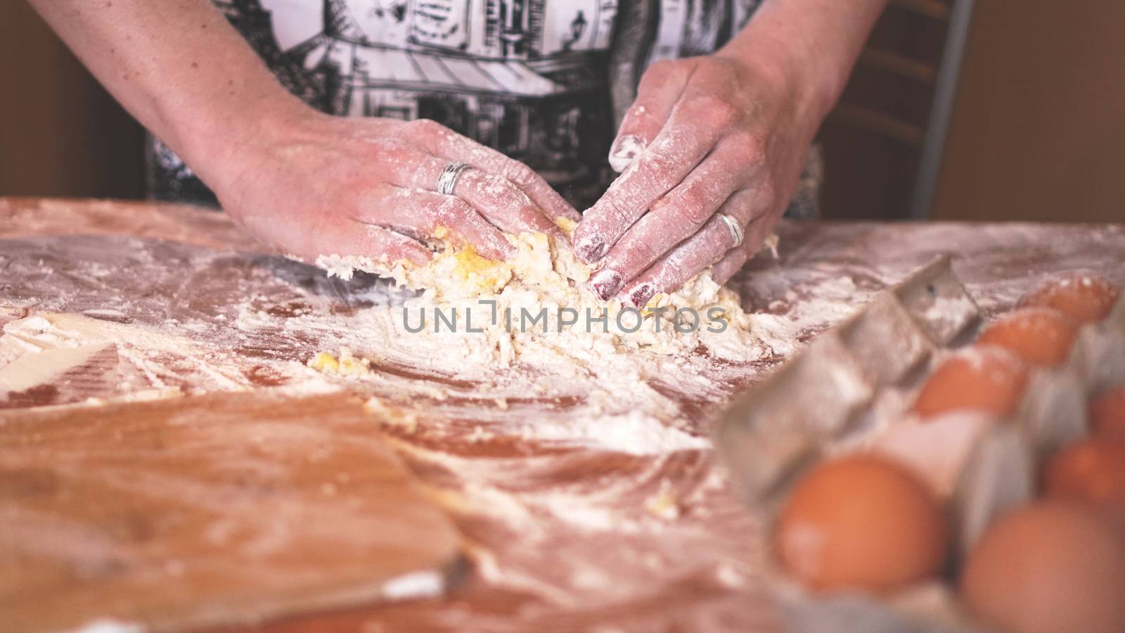 Cooking and home concept - close up of female hands kneading dough at home by natali_brill