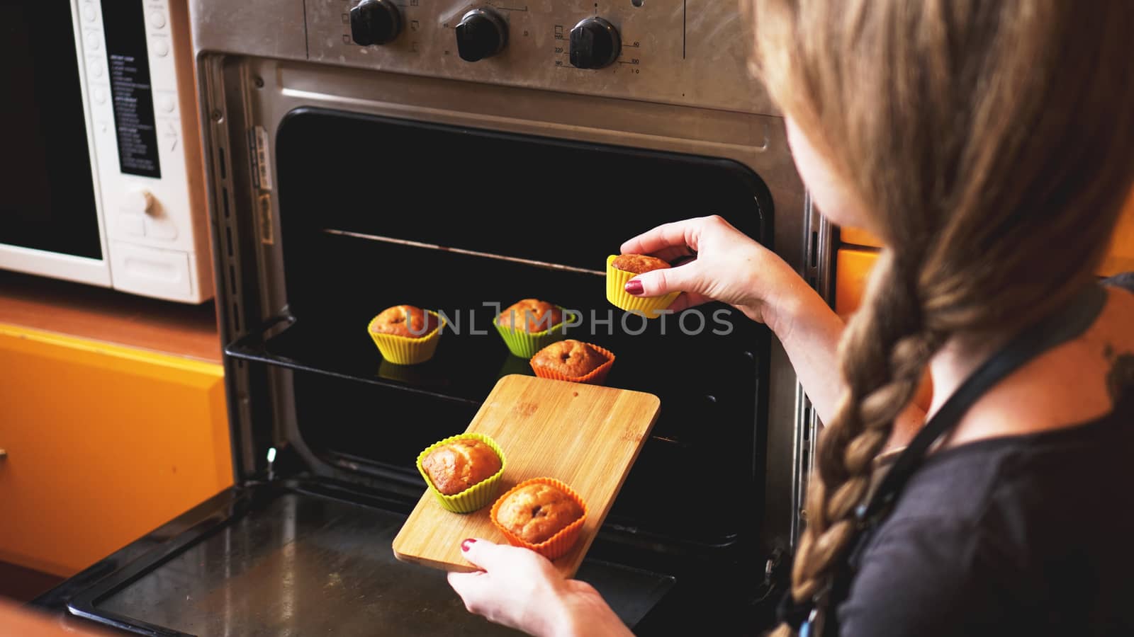 Close-up muffins ready to get out of electric oven. Concept of cooking home cake by natali_brill