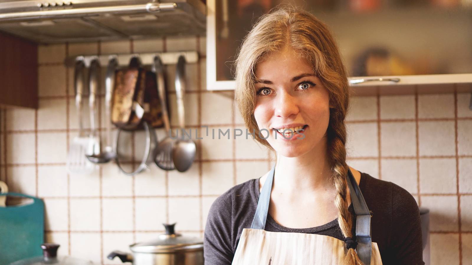 Portrait of beautiful woman at home in kitchen lifestyle. Cooking and home concept