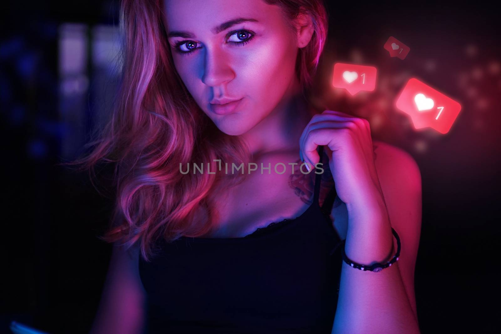 Lucky charming woman of 23 years with signs in form of like from social network - Sexy girl in neon red and blue light