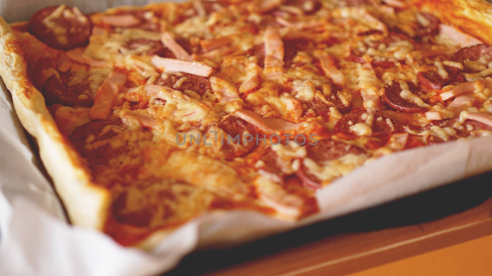 Simple Homemade Pizza on a rustic wooden table.