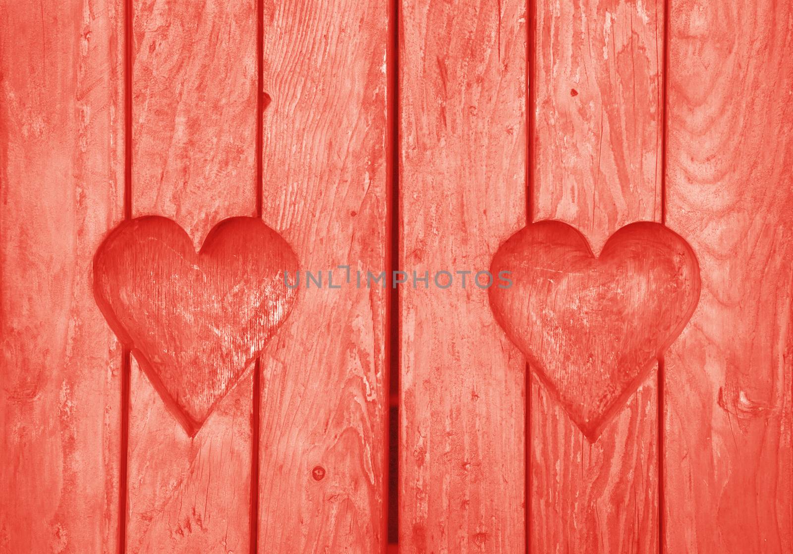 Two heart shapes carved in vintage wood close up by BreakingTheWalls