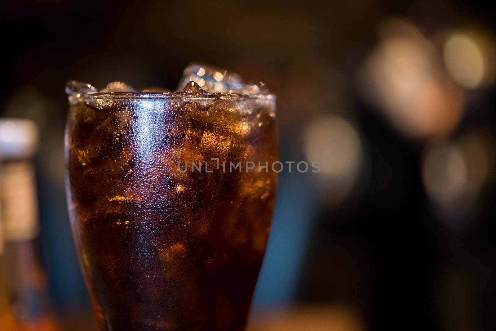 glass of cola with ice by antpkr