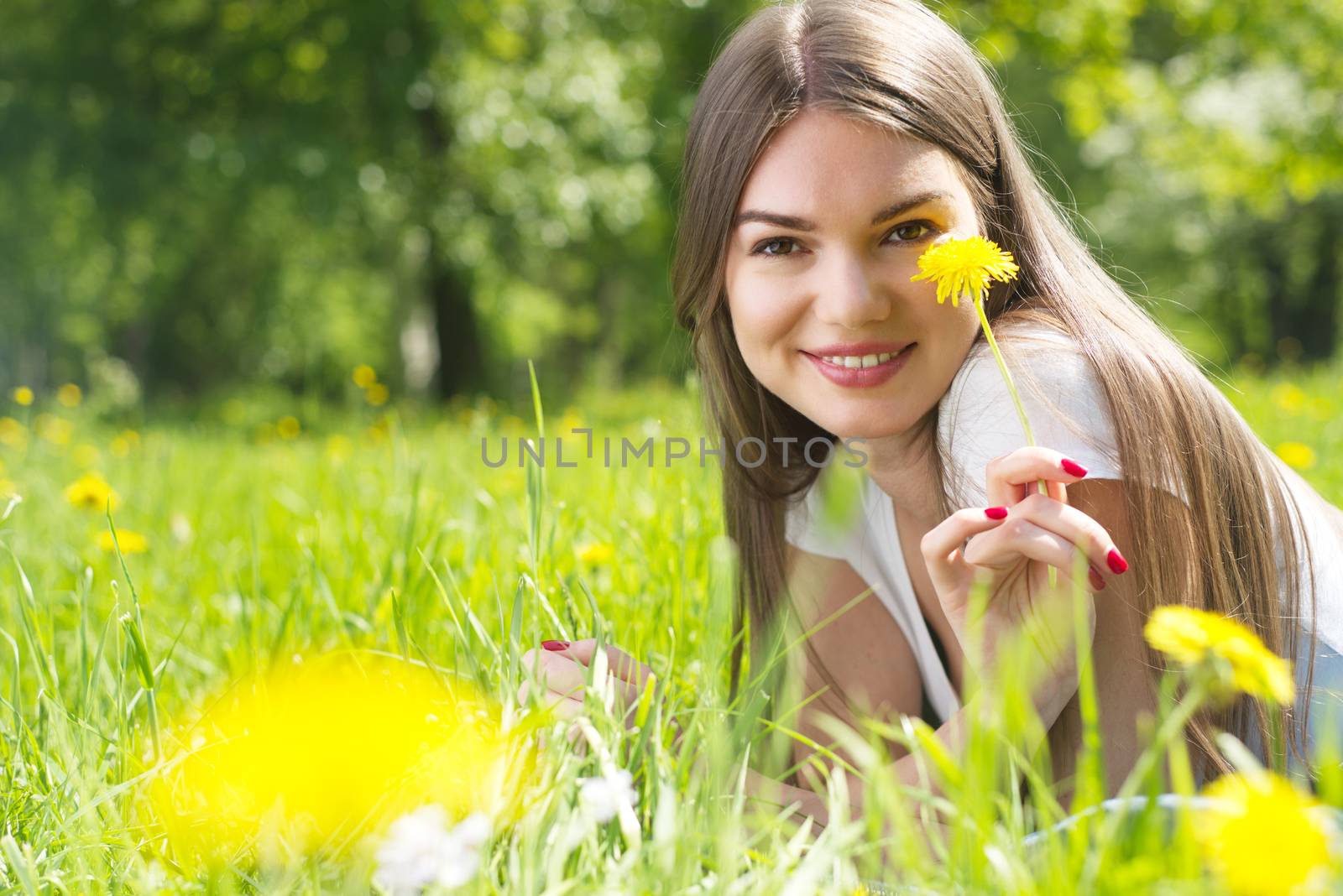 Woman laying on grass in park by ALotOfPeople